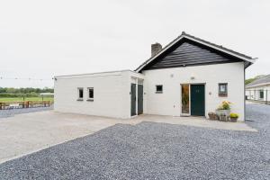 a white building with a black roof and a driveway at University Tilburg Affordable Room Walk In Nature in Tilburg