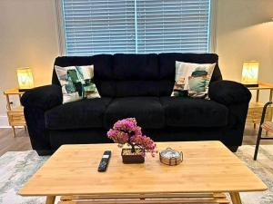 a living room with a black couch and a coffee table at Well-Equipped 2BR Unit with Parking - GBay 301 in Evanston