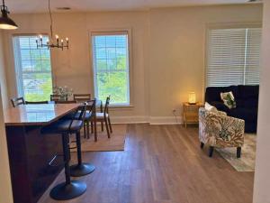 a kitchen and living room with a table and chairs at Well-Equipped 2BR Unit with Parking - GBay 301 in Evanston +40 photos