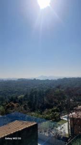a view from the roof of a house with the sun in the sky at Espaço Nosleda in Santana de Parnaíba