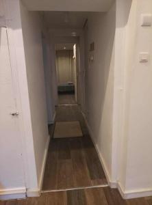 an empty hallway with a hallway leading into a room at Appartement entier 1 in Saint-Léonard-de-Noblat