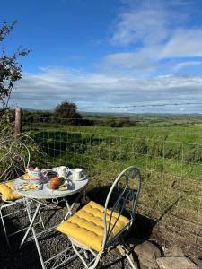 a table and chairs with a plate of food on it at Country Cosy Cottage in Bailieborough +58 photos