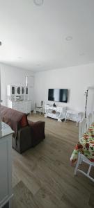 a living room with a couch and a flat screen tv at Boa Passagem AL in Bicas