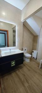 a large bathroom with a sink and a toilet at Boa Passagem AL in Bicas