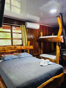 a bedroom with a bed in a room with wooden walls at Hotel La Isla Inn in Puerto Viejo +46 photos