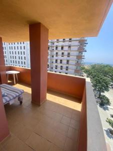 a balcony with a view of a large building at vistas al mar in Torre del Mar