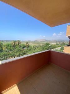 a balcony with a large window with a view at vistas al mar in Torre del Mar