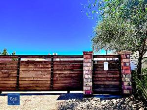 a wooden fence with a gate in a yard at Casa Poriá - Guadalupe Valley in Valle de Guadalupe