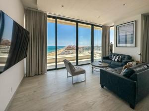 a living room with a view of the ocean at Waves & Views Luxury 3BR Oceanfront Condo in Puerto Peñasco