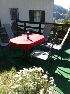 a red table and chairs on a patio at Ferienwohnung 2 Ferienhaus Gassner In Navis in Navis +10 photos