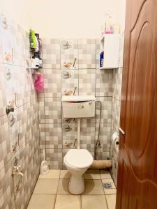a small bathroom with a toilet and a sink at Nyumbani Studio in Ukunda Airport