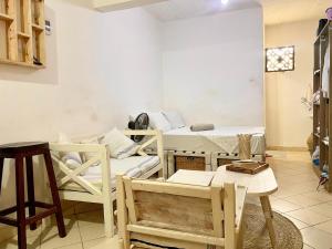 a room with two bunk beds and a table at Nyumbani Studio in Ukunda Airport +3 photos
