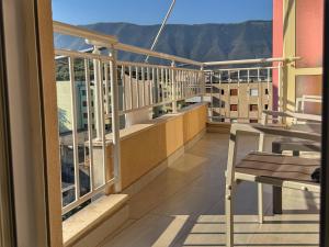 a balcony with tables and chairs on a building at Orikum Getaway in Orikum