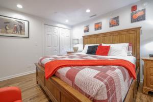 a bedroom with a bed and a red chair at Harmony Inn, Huntley Illinois in Huntley