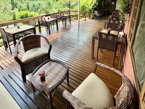 a balcony with chairs and tables and tables at Hotel Fazenda Vale Alvorada in Cascavel
