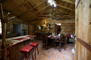 a room with a table and chairs in a cabin at Cabaña Flor de Agave in Tres Marías +14 photos