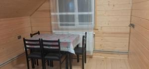 a table with two chairs and a table cloth on it at Home comfort in Verkhovyna