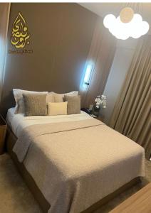 a bedroom with a large bed with a white blanket at Broadway Hotel in Dubai