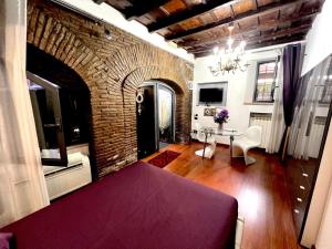 a living room with a table and a brick wall at Domus31 - Luxury House in Trastevere in Rome