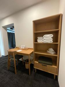 a room with a desk and a shelf with towels at Amma Jóna rooms in Ásólfsskáli +61 photos