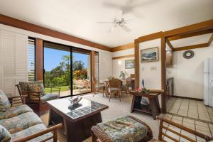 a living room with a couch and a table at Kiahuna Plantation 323 in Kipu