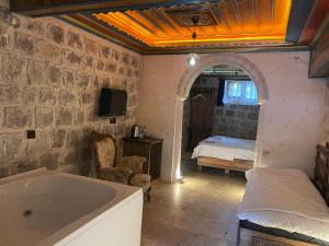 a bathroom with a tub and a bedroom with a bed at Era Cappadocia in Uçhisar +44 photos