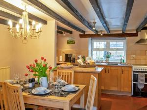 a kitchen with a wooden table and a dining room at 3 Bed in Hartington 90125 in Hartington