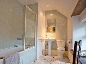 a bathroom with a tub and a toilet and a sink at 3 Bed in Hartington 90125 in Hartington +20 photos