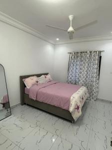 a bedroom with a bed and a ceiling fan at Kotu lux in Kotu +7 photos