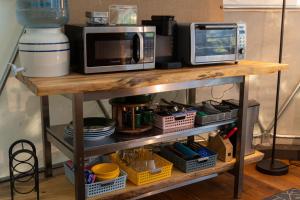 a microwave oven sitting on top of a table at North Cascades Glamping with Hot-tub and Outdoor Kitchen in Rockport