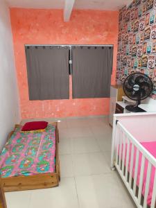 a small room with a bed and a window at Casa Avance RH Aconchego in Camaçari +11 photos