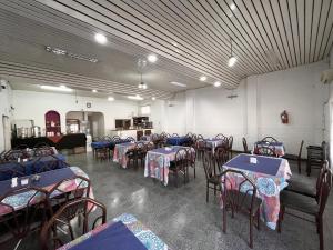 a room filled with tables and chairs with blue tables at Hotel Patios de Salta in Salta