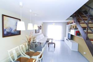 a living room with a table and a dining room at Magica Planetcostadorada in Cambrils