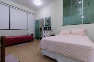 Ένα ή περισσότερα κρεβάτια σε δωμάτιο στο Loft dos Beija Flores