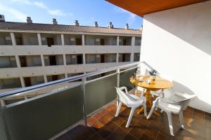 a balcony with a table and chairs and a building at Mexico Planetcostadorada in Vilafortuny