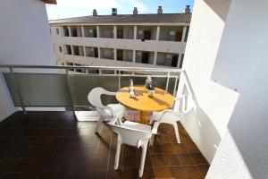 a table and chairs on a balcony with a building at Mexico Planetcostadorada in Vilafortuny