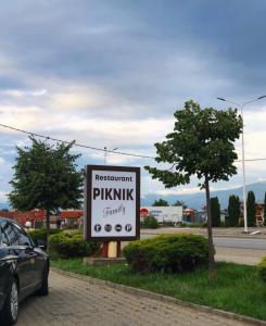 a sign for a pharmaceutical pharmacy on the side of a road at Restaurant Piknik in Prizren