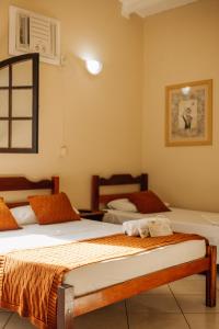 a bedroom with two beds in a room at Pousada Florescer in Ubatuba
