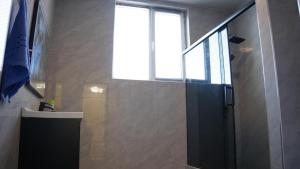 a bathroom with a black door and a window at Royal Pool Cottage in Shymkent +16 photos