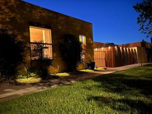 a house with a sidewalk next to a fence at Mishu's Place in Roswell