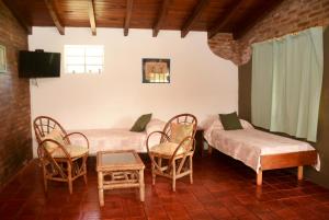 Postel nebo postele na pokoji v ubytování LA TOMA Complejo de Montaña - Cabañas y Habitaciones en Hosteria + 85 fotografií