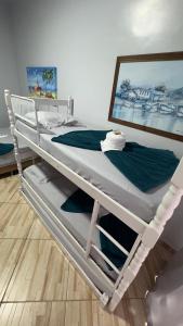 a white bunk bed sitting in a room at Pousada Vista Horizonte in Penha +46 photos