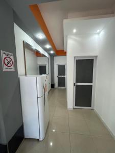 a kitchen with a white refrigerator in a room at Departamento Rojas 1 in San Fernando del Valle de Catamarca