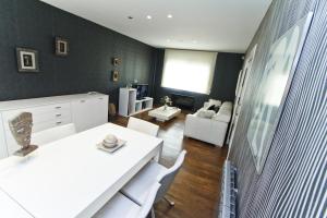 a living room with a white table and white chairs at Dream Planetcostadorada in Salou