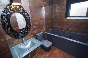 a bathroom with a sink and a tub and a mirror at Dream Planetcostadorada in Salou
