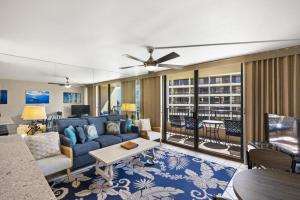 a living room with a blue couch and a table at SUGAR BEACH RESORT, #409 condo in Kihei