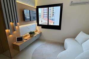 Televisyen dan/atau pusat hiburan di Residencial Vivant - Perto de TUDO! LZN Hospedagens