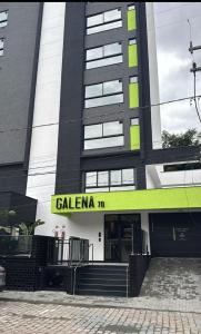 a building with a yellow sign on the front of it at Loft Moderno no Centro de Blumenau in Blumenau