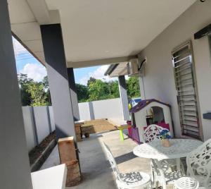 a patio with a table and chairs and a play house at Summerset Guesthouse in Kuching