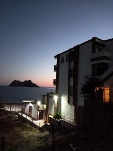 a building next to the ocean at night at Mision del Sol 302 in Bahía Kino